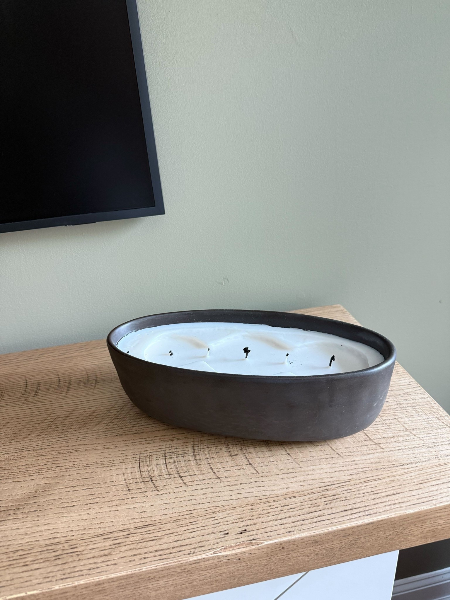 Even unlit, this oversized Walmart candle doubles as a sculptural piece on the Pottery Barn fireplace. The textured wood mantel helps warm up the space against the olive green walls. Adds cozy living room vibes without breaking the budget.

#LTKHome #LTKOver40 #LTKStyleTip