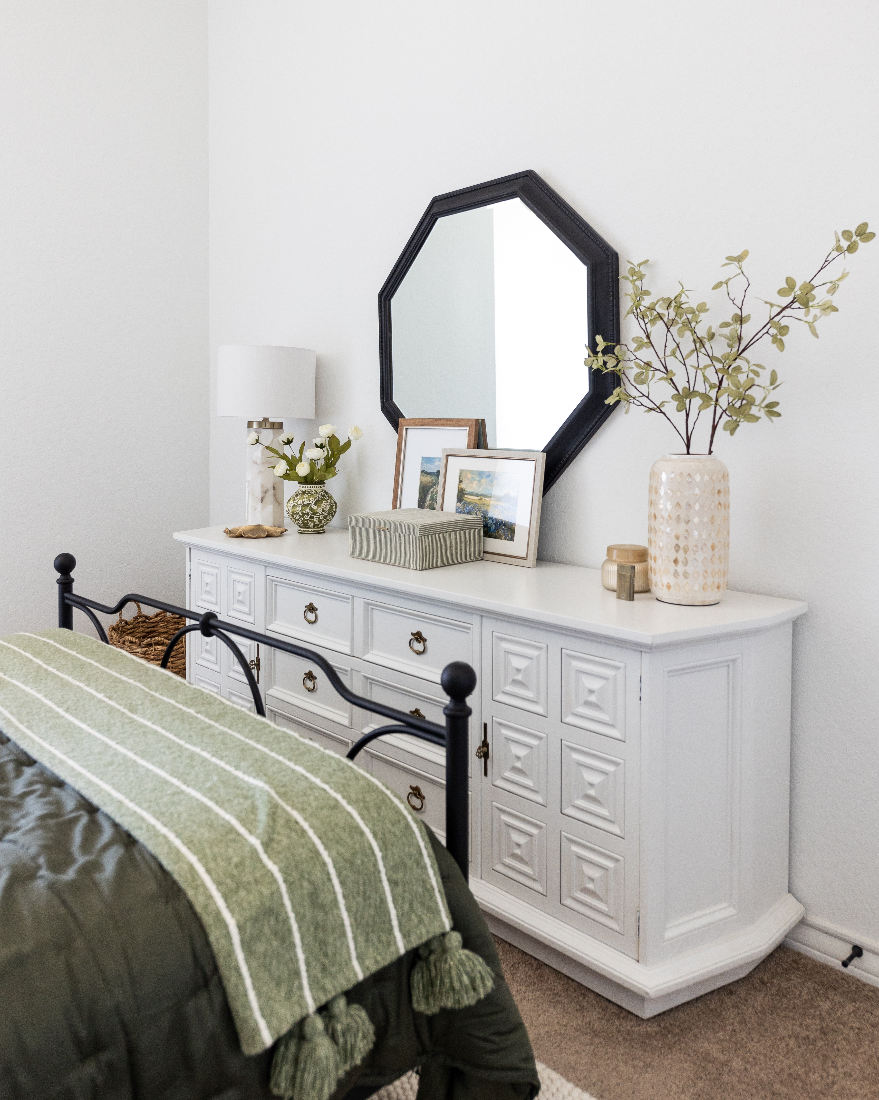 One of the most rewarding projects in this room was refinishing this antique dresser. Instead of replacing it, I gave it new life with fresh paint and styled it with classic decor that feels simple and timeless.

The black mirror adds contrast, while layered artwork, textured storage, soft florals, and ceramic accents bring warmth without feeling cluttered. It's a look that's easy to recreate with a mix of vintage finds and affordable home decor. 

 #LTKHome #LTKSaleAlert