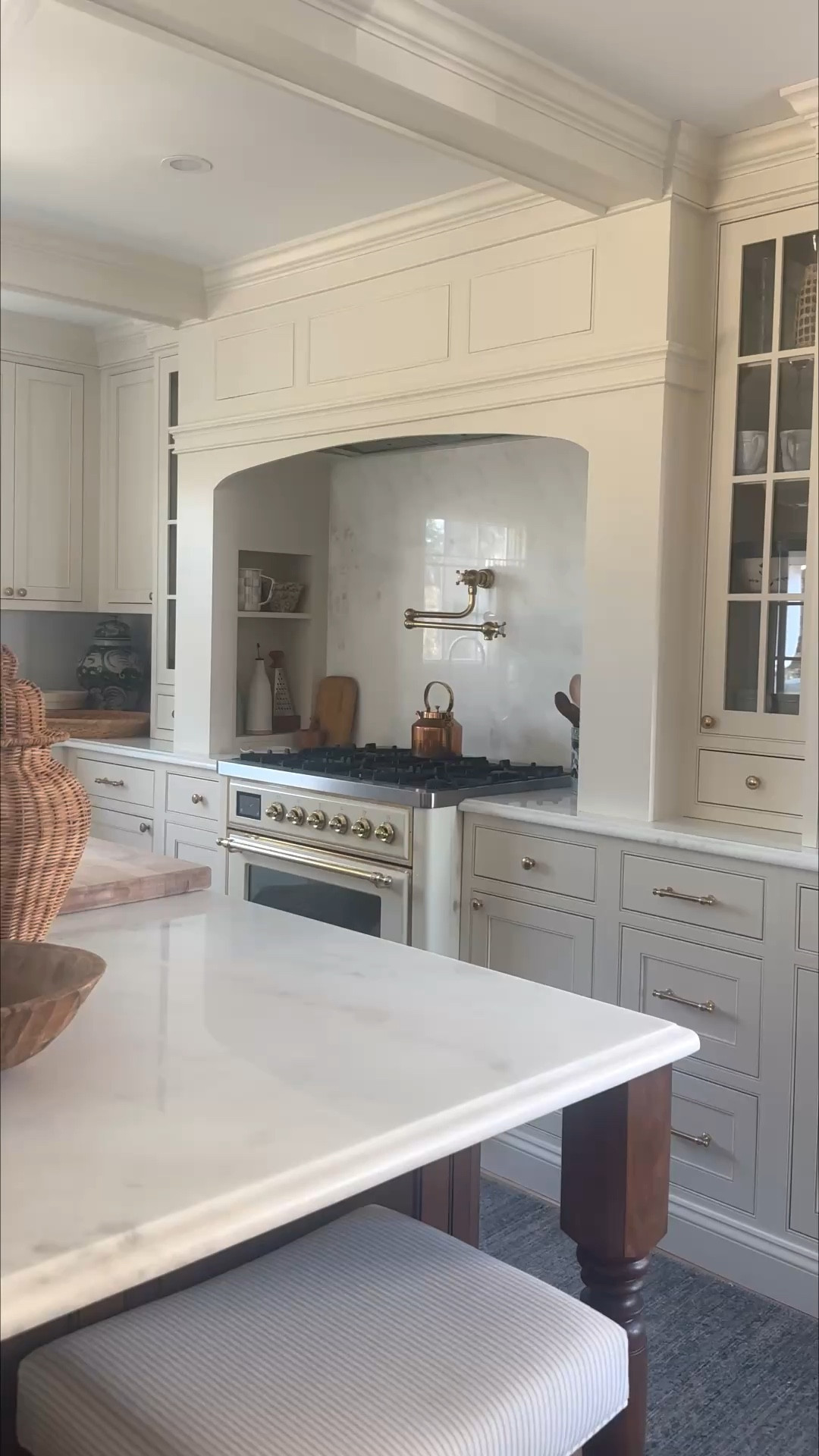 Choosing a creamy white can be crippling! I’m beyond thrilled with the variety of tones each paint color brings throughout the day. Sometimes a little butter yellow, sometimes straight cream, and sometimes a white feeling. All to bring layered, airy and light feels to the space! 

Here’s the exact lineup:

Cabinets: White Duck by SW is the color match to the Antique White factory finish by The Cabinet Joint. You will see the White Duck paint on the custom range alcove and beams. Seamless!

Walls: Cloud Cover by BM 

Trim: Pure White by SW

Comment SHOP for links and to read all about the space! 