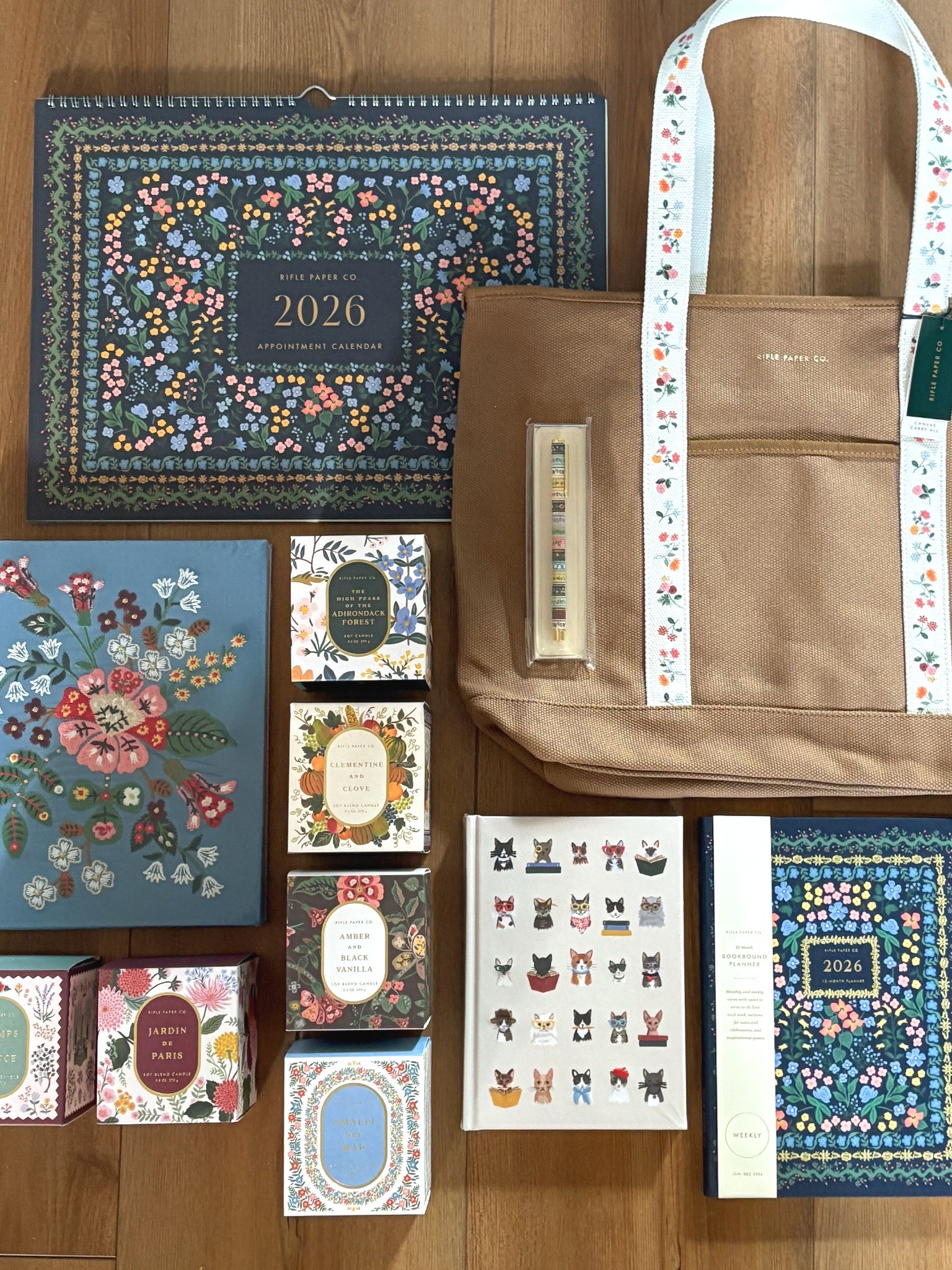 Rifle Paper Company goodies - wall calendar, tote bag, pen, embroidered sketchbook, journal, 2026 planner, and some amazing smelling candles!

#riflepaperco
@riflepaperco