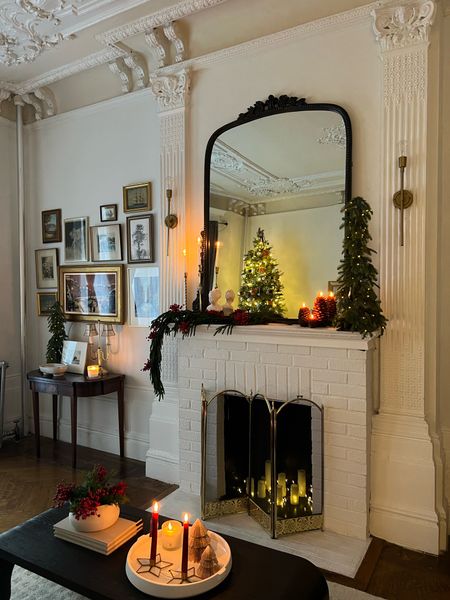 Living room Christmas decor- mantle mirror, sconces, pre-lit mini tree, pinecone candle, frame tv 

#LTKhome #LTKHoliday #LTKstyletip
