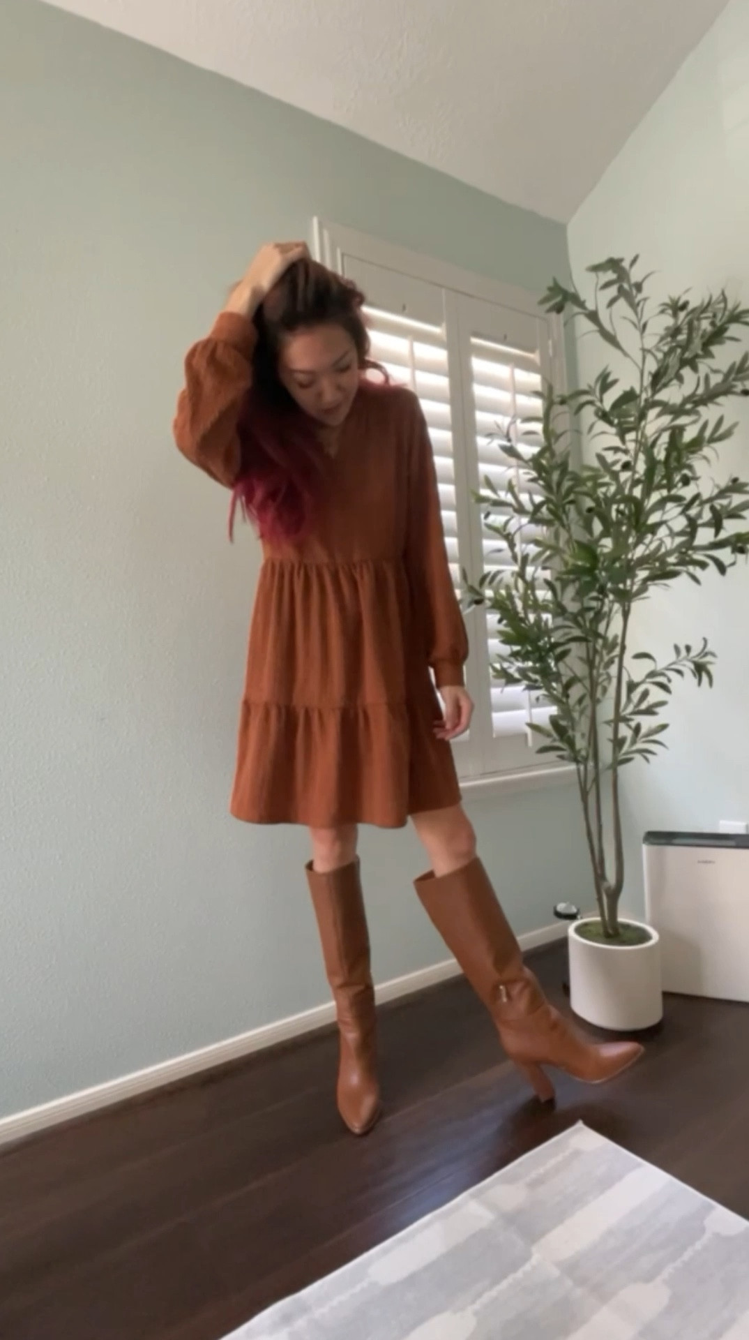 Fall 2024 style tip: Pair tall boots with dresses and skirts / skorts because in. 2025 we aren’t tucking skinnyjeans into tall boots anymore. 

Update your look by styling fall sweater dresses  - if it’s still warm where you live, this faux cable knit is lightweight enough to wear to the pumpkin patch even on warm days. 

This season’s color palette is filled with browns, tan, and shades of caramel brown. So i’m going all in with head to toe brown dress and knee high boots. 

- - - 
For content creators - I’ve also linked the auto tracking tripod that I used to self-record this video.

Faux olive tree also linked. 

#LTKVideo #LTKShoeCrush #LTKxPrimeDay