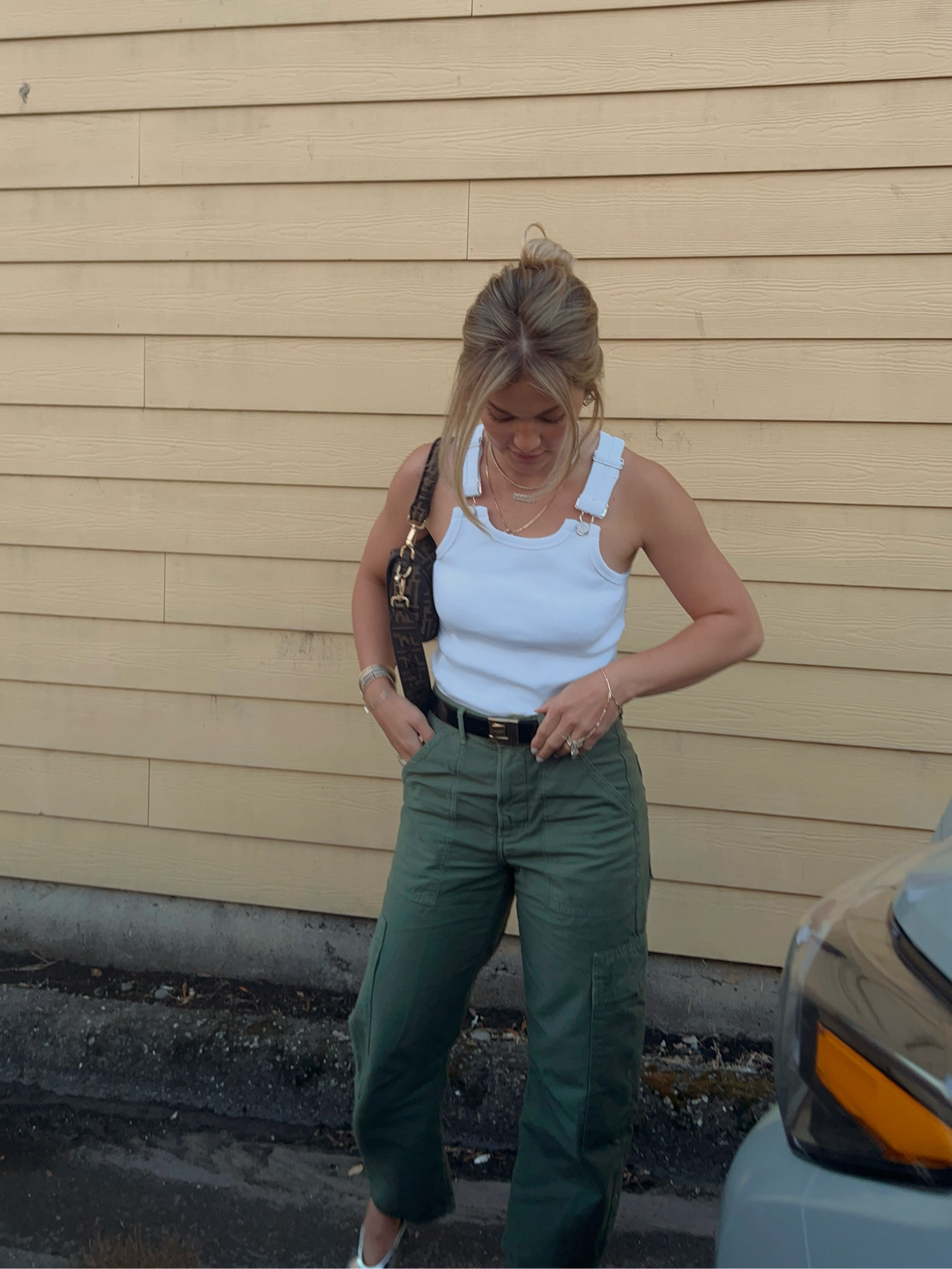 green cargo pants, white tank, Fendi bag 