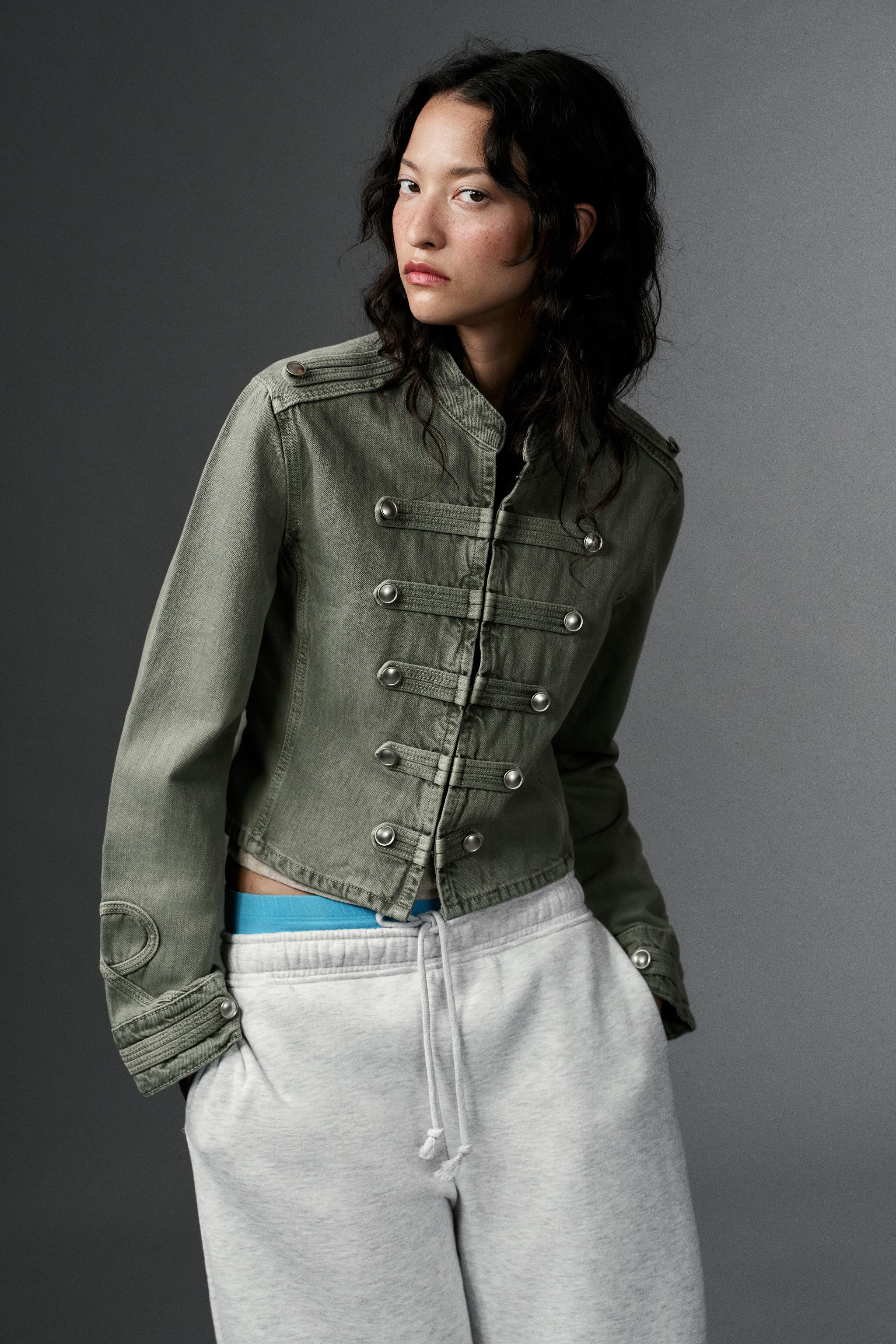 Round neck, long sleeve jacket with tabs. Featuring button details and applications in the same f... | Zara UK