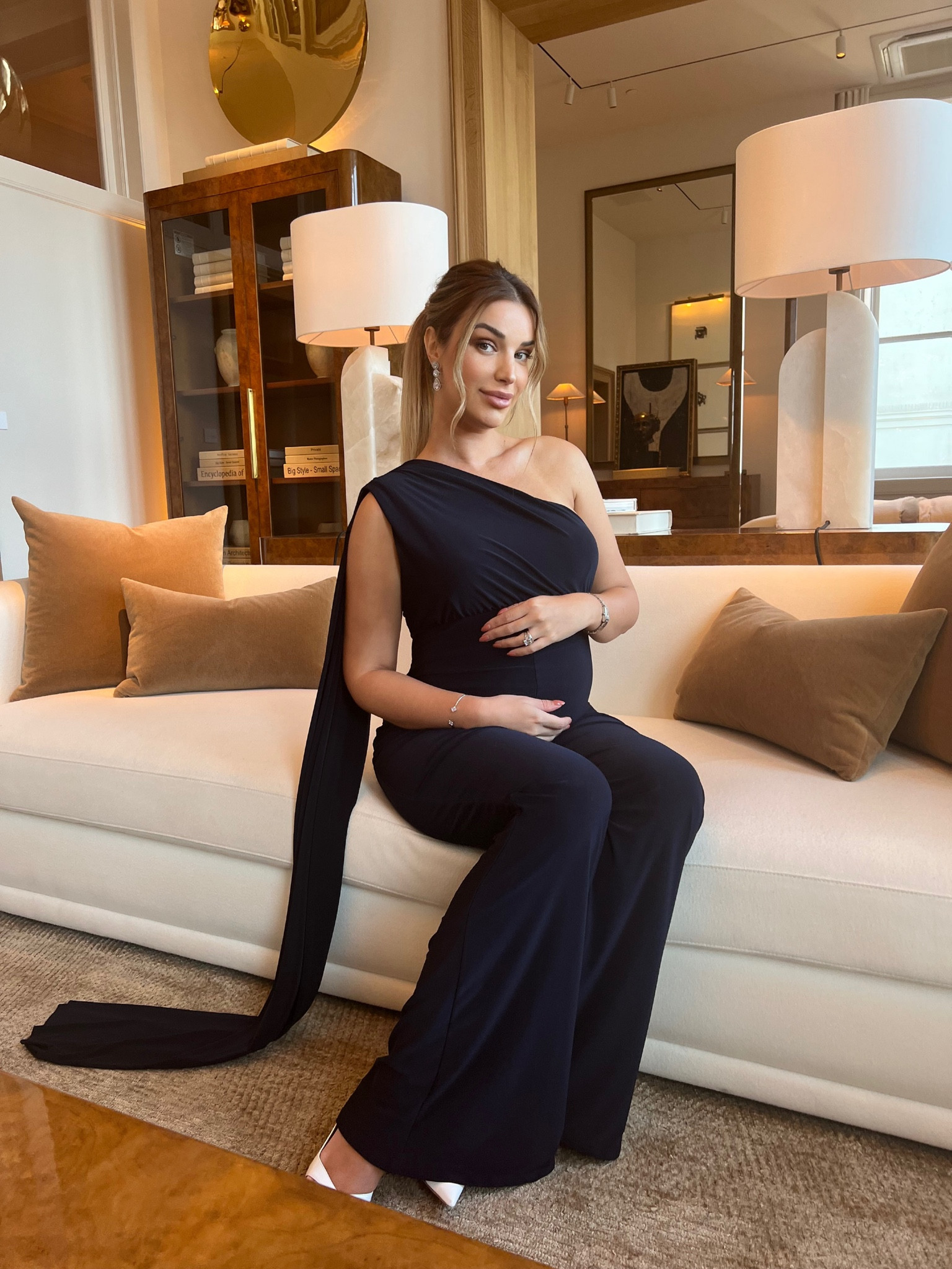 Jumpsuit for that special occasion in elegant style. Constructed in a premium jersey fabric to sculpt and flatter your bump in comfort, this sophisticated all-in-one is the perfect statement alternative to a cocktail dress. With a dramatic neckline that has an over-the-shoulder drape forming a cape-effect, this striking pregnancy jumpsuit will turn heads and ensure you command the room, babe. The wide-leg cut is super-flattering and will elongate your pins, while the asymmetric neckline with ruched detail will enhance your gorgeous décolletage.

#LTKGiftGuide #LTKbump #LTKHoliday