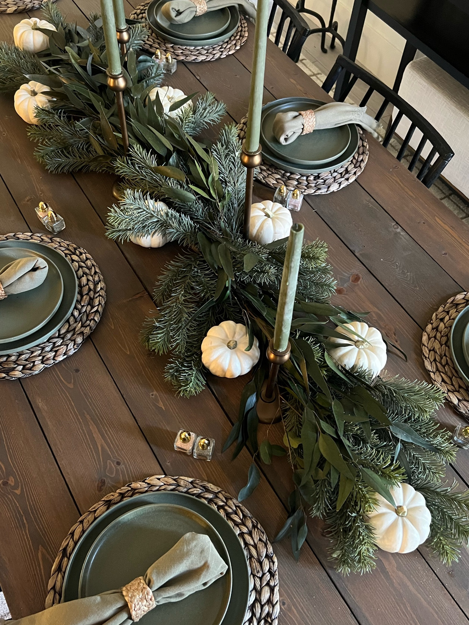 Thanksgiving table! I created this centerpiece/runner with faux pine stems and preserved eucalyptus. 
The pumpkins are real! 
Fall/Autum dinner table, holiday hosting 