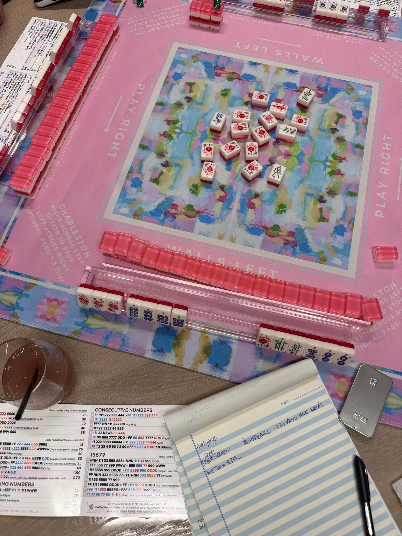 Not the exact same set, mine is from Sam's Club last year (rumors are they are bringing it back). But this set is from the same company and is an all in one set to get started! 

I ended up buying another mat and love the Big Card from The Mahjong Line. 

DO NOT get an overly cute set for your first set if they're hard to read you want near  traditional symbols and contrast on the tiles. 

Ohh and I take notes. Haha.