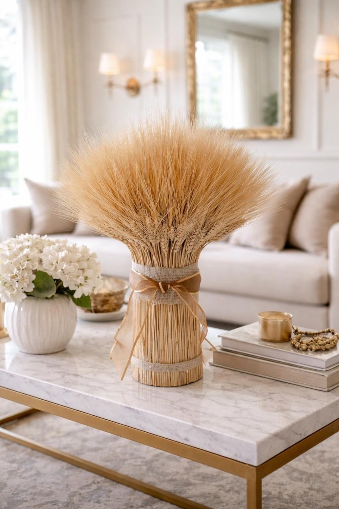 Add a touch of golden harvest charm to your home with the Sunhaven Wheat Stack 🌾 This beautifully gathered bundle of blond wheat is tied with burlap and sheer ribbon, creating a simple yet elegant accent for coffee tables, shelves, or entry consoles. The natural texture and warm tones bring timeless farmhouse style to any space, and with proper indoor care it can last for years. Grown, harvested, dried, and handcrafted on a U.S. farm, each piece is truly one of a kind.

#ltkhome #farmhousedecor #driedwheat #naturaldriedflowers #rusticdecor #homedecorinspo #neutralhome #harvestdecor #timelessstyle #ltkfinds

#LTKSpringSale #LTKSeasonal #LTKHome