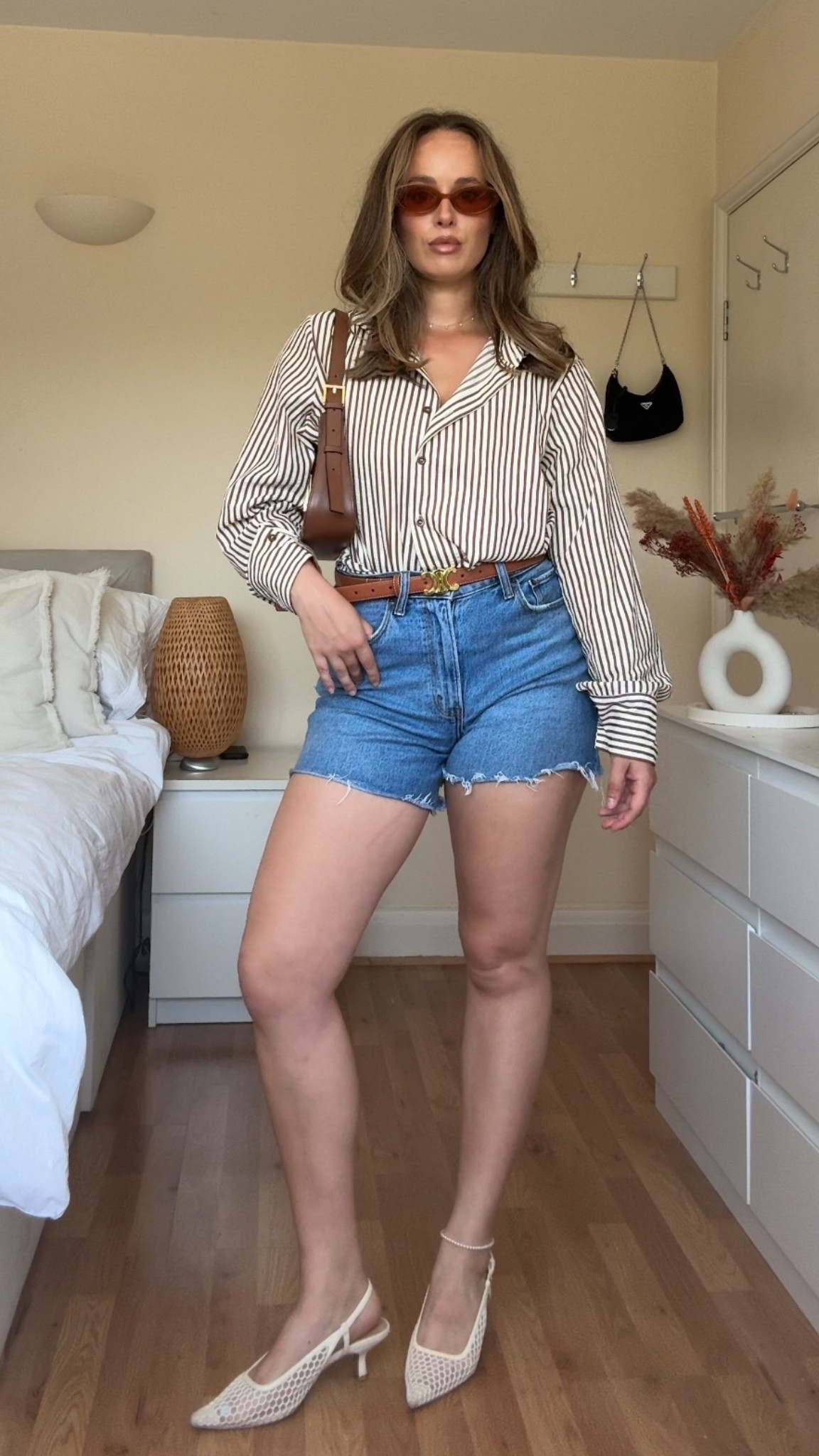 Classic summer formula: crisp stripes + denim cutoffs 🤎
Wore this for a sunny day in the city — comfy but polished thanks to the woven kitten heels. This shirt gives major Zara energy (still waiting to be approved to link them 👀), so I’ve linked similar styles you can shop now.”

#LTKstyle #LTKsummer #StripesAndDenim #EffortlessStyle #SummerOOTD #MinimalStyle #CityOutfit

#LTKeurope #LTKuk #LTKsummer