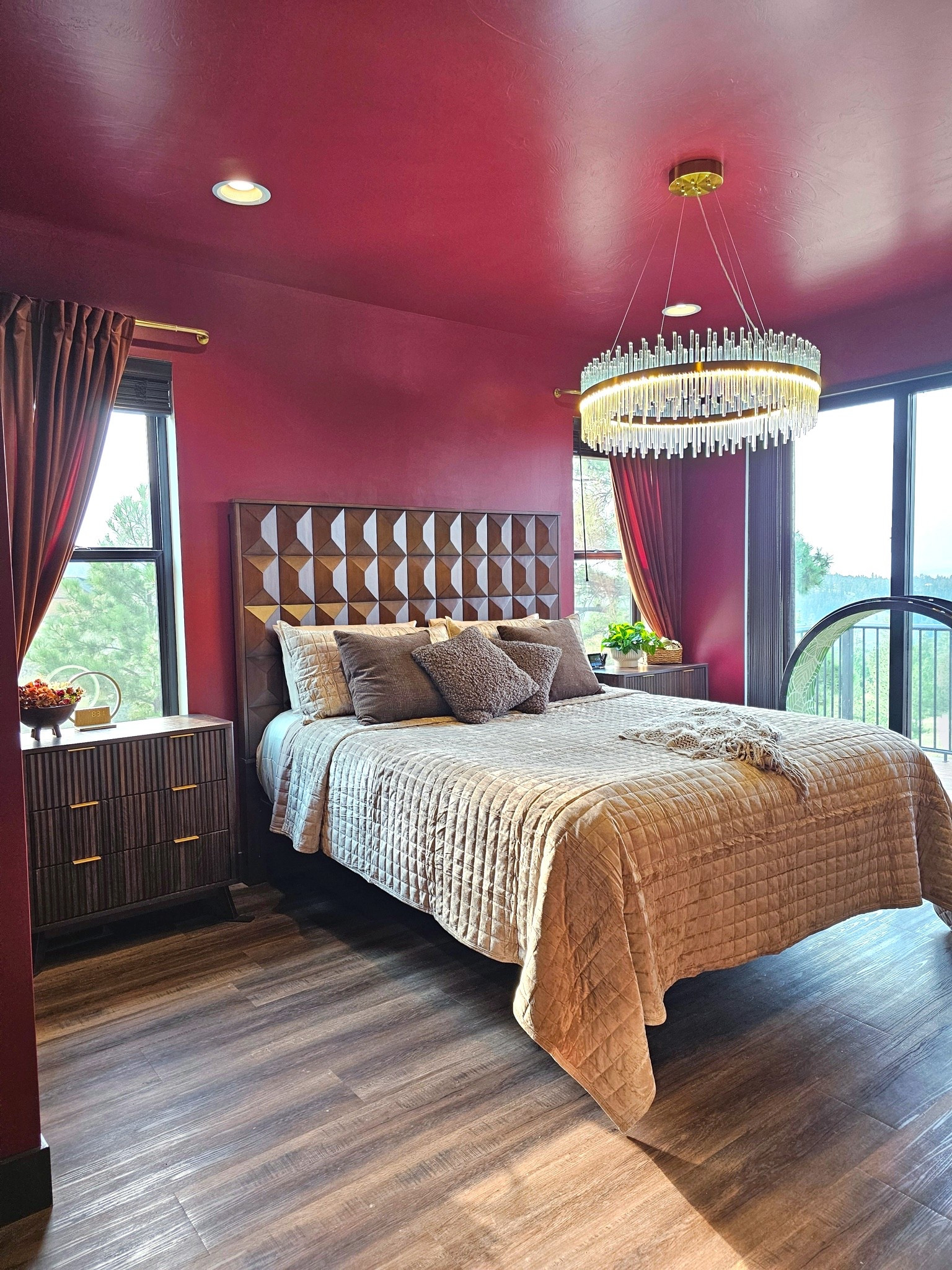 Moody luxury bedroom makeover featuring bold raspberry burgundy color-drenched walls and ceiling, a geometric wood tall headboard, and a modern brass and crystal fringe chandelier. Recreate this dark academia chic master bedroom with textured neutral bedding, fluted wood nightstands with brass hardware, and floor-to-ceiling velvet drapery.

Bedding: Beige waffle knit coverlet, quilted throw blanket, cozy textured accent pillows

Furniture: Modern fluted wood 3-drawer nightstand / small dresser, tall brown wood geometric patterned headboard, king/queen bed frame

Lighting: Glam round crystal halo chandelier, warm recessed LED lighting, modern brass pendant fixture

Window Treatments: Luxury burgundy velvet curtains, brass curtain rods

Flooring & Decor: Rustic oak luxury vinyl plank (LVP) flooring, ceramic planter, gold metal ring tabletop accent

#LTKhome #LTKstyletip #LTKunder100 #LTKFind

#MoodyBedroom #ColorDrenching #MasterBedroomInspo #BedroomDesign #MoodyInteriors #DarkAcademiaHome #GlamChandelier #FlutedFurniture #ModernLuxe #HomeDecorInspo #BedroomMakeover #VelvetCurtains #InteriorDesignInspo 

 #LTKHome