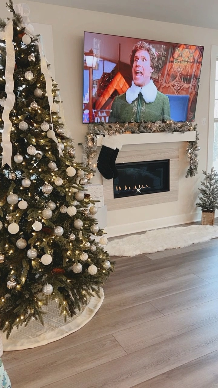 Christmas tree decorations + holiday decor that will cozy up your space this holiday season🎄✨

Here, we decorated our artificial Christmas tree with white and silver ornaments for a glitz + glam holiday look. I used white and silver wrapping paper to match when placing presents under the Christmas tree. We used a white cable knit tree skirt. I made the Christmas tree topper bow from white and silver wired ribbon. 

We added more texture to cozy up our living room with a white faux fur rug infront of the fireplace. We hung flocked garland and green stockings along the mantel. We wrapped matching flocked garland around the stair railings. At the end of each banister, I added a white and silver wired ribbon bow and silver jingle bells. 

The flocked artificial mini tree and white lantern helped add classy Christmas decor to our home. We hung green and plaid blankets from our blanket ladder. We added matching green pillow covers on the throw pillows on the couch. 

#LTKHome #LTKHoliday #LTKSeasonal