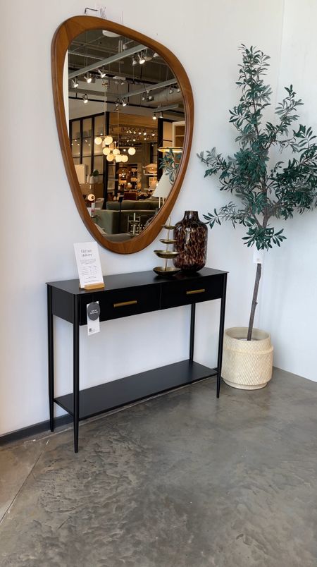 Minimalist modern entryway inspo! 🖤 Sleek simple black metal console table paired with a rustic wood, irregular-shaped mirror! 

#LTKHome #LTKSaleAlert #LTKVideo