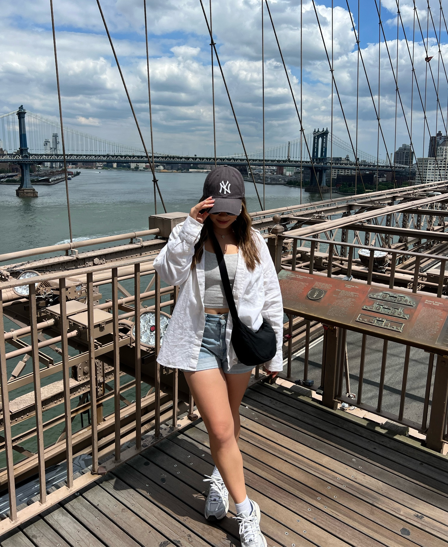 Casual every day summer outfit for spending a day in New York City. Wearing a grey cotton rib tank from Skims, a white oversized linen shirt from Abercrombie, light blue shorts, and a grey New York logo baseball hat. Paired with beige New balance 530 running shoes and a black crossbody bag from Uniqlo. 

#LTKsummer #LTKcanada #LTKtravel