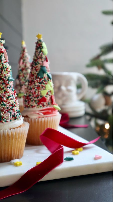 Using store bought or homemade cupcakes, you can easily make this fun and whimsical holiday treat! 
Frost a sugar cone and then roll in sprinkles. Turn upside down on top of a cupcake then add a star to the top. Aren’t these so cute?! 

#LTKSeasonal #LTKparties #LTKHoliday