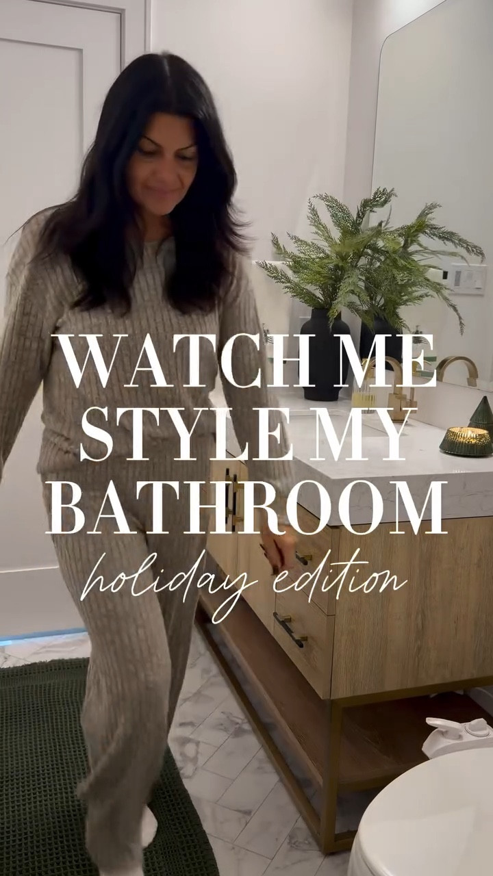 Follow + type HOLIDAY BATH for a 🔗 I couldn’t resist the viral bath mat in this stunning green—instantly sets the holiday vibe and yes… it’s 100% worth the hype. I swapped in a taller vase with pine stems for height, added the cutest Christmas-tree towels, a little gold reindeer moment, and the prettiest green mercury-glass tree candle (it smells incredible). Then I finished it off with a DIY swag of pine and brown ribbon draped over my wall art.

Simple swaps, major holiday glow. I’m obsessed with how it turned out. 🎄

✨ My cozy lounge set is also linked! I have it in 4 colors and love it! Would make a great gift 🎁