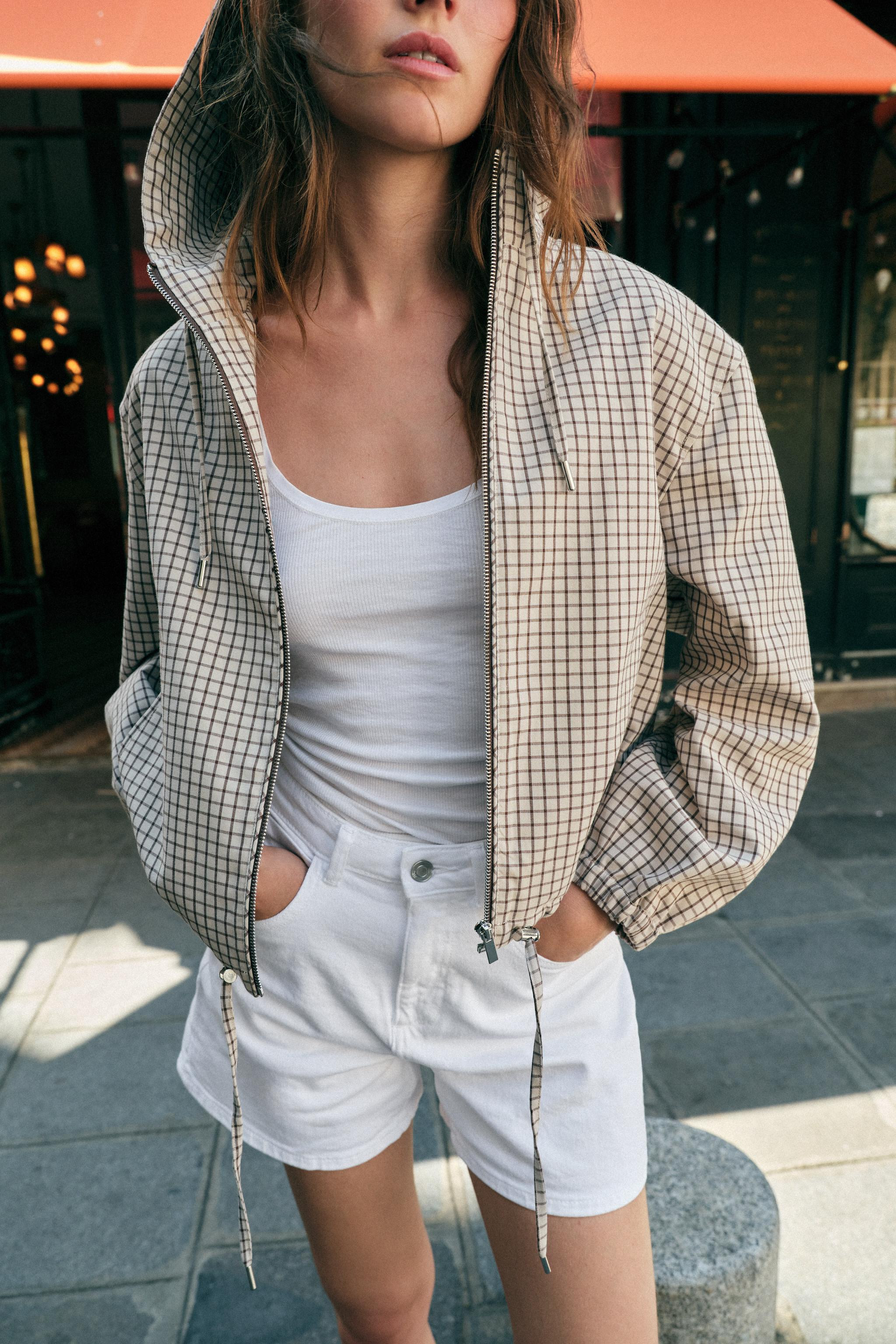Jacket with adjustable drawstring hoodie and long sleeves with elastic cuffs. Double welt front p... | Zara US