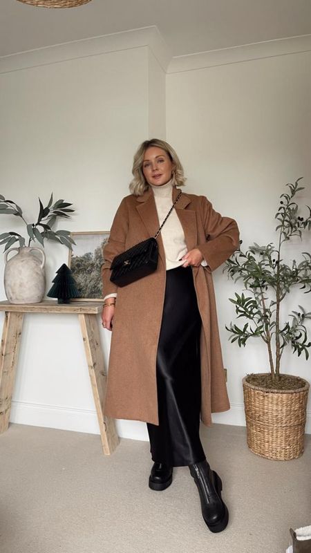 Ways to wear a black satin skirt - cosy winter outfit. Mango brown oversized coat, H&M black lined zip front boots and H&M beige roll neck jumper  

#LTKstyletip #LTKeurope #LTKSeasonal
