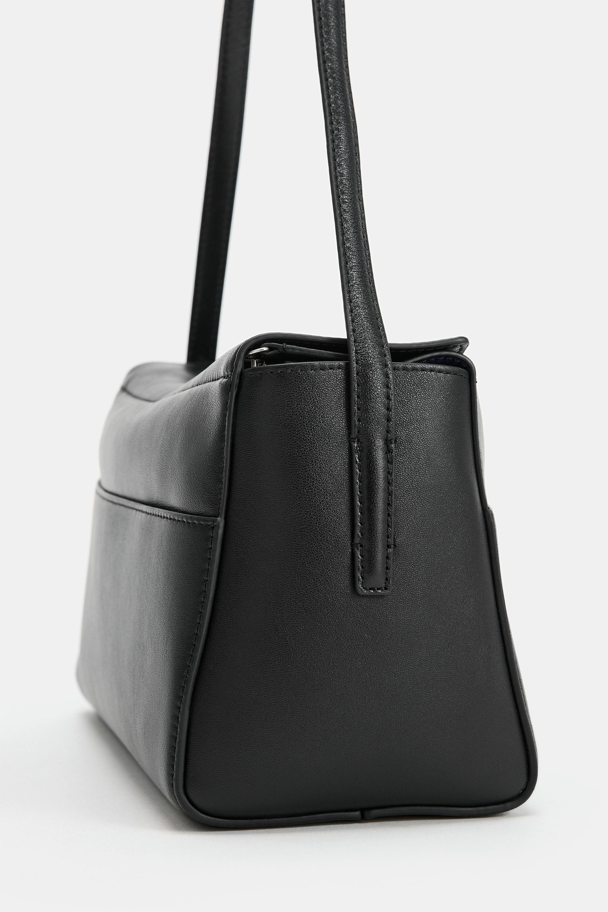 Leather shoulder bag with stitched detailing. Contrasting interior. Features a shoulder strap and... | Zara UK