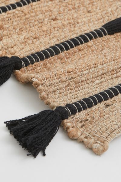 Bath mat in braided jute with contrasting stripes in woven cotton fabric. Large tassels at short ... | H&M (US + CA)