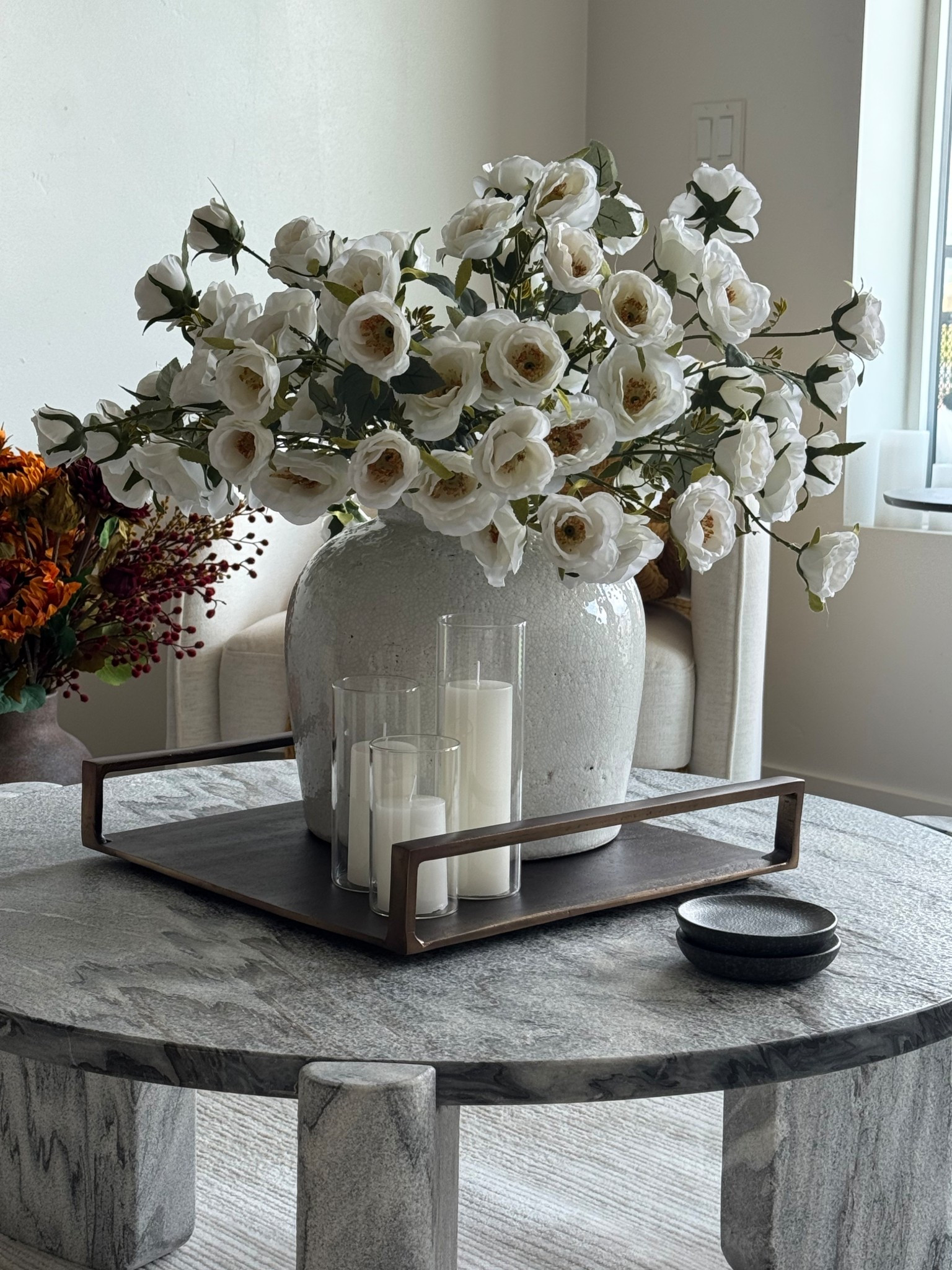 My dream coffee table & centerpiece. I’ve always wanted something that feels timeless 💕 These faux florals are amazing quality, realistic, and dangly. I’m not even going to link a dupe because I don’t think you’ll find better than this. These came as a set for $99. So all the florals came together for that price, and they filled the vase. They’re from the website Contempee. The Arhaus tray, coffee table, and vase is all on sale currently for Labor Day  

#LTKHome #LTKSaleAlert #LTKSeasonal
