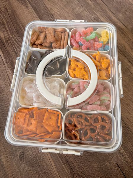 “Snackle box” for sports moms. The perfect snack box that has 8 removable cups that are deep and hold a lot of snacks. Snap top closes to hold with a handle and fits perfectly in our Bogg bag. 

#LTKFamily #LTKKids #LTKTravel