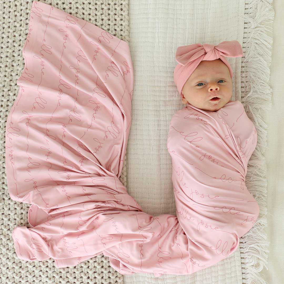 Personalized Light Rose on Pink Baby Name Swaddle Blanket - Script | Caden Lane