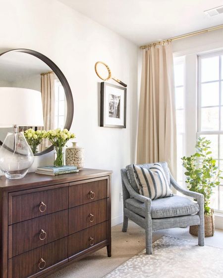 A handsome bedroom corner I designed with Frontgate featuring their mid-century armchair, reeded wood dresser, black metal round mirror, oversized lamp, faux bush, blue pillow

#LTKstyletip #LTKhome #LTKFind