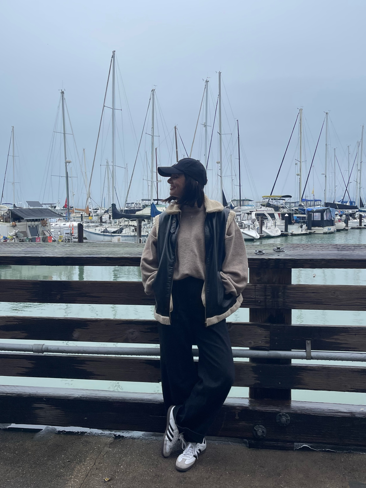 Winter outfit idea 
Brown sweater with teddy lined vest 
Black baggy jeans 
Black baseball cap and 
Adidas sambas 

#LTKstyletip #LTKSeasonal #LTKshoecrush