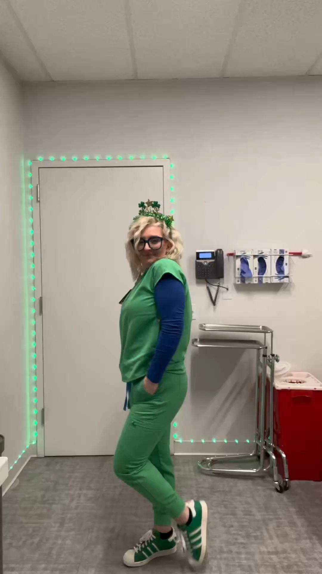 Festive workwear look with green scrubs, a blue layering top, and matching sneakers ☘️ Linked this look with similar pieces.