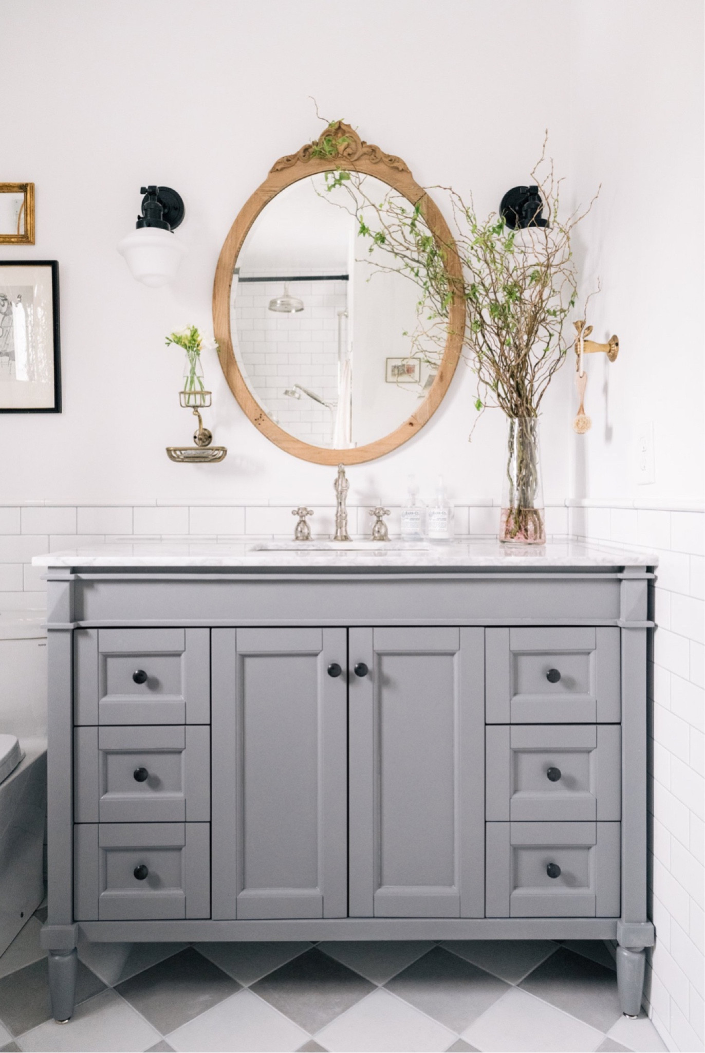 Our guest bathroom is a mix of new and vintage pieces. I love this vanity with all the drawers for organizing and the cross knobs are so charming  

#LTKhome