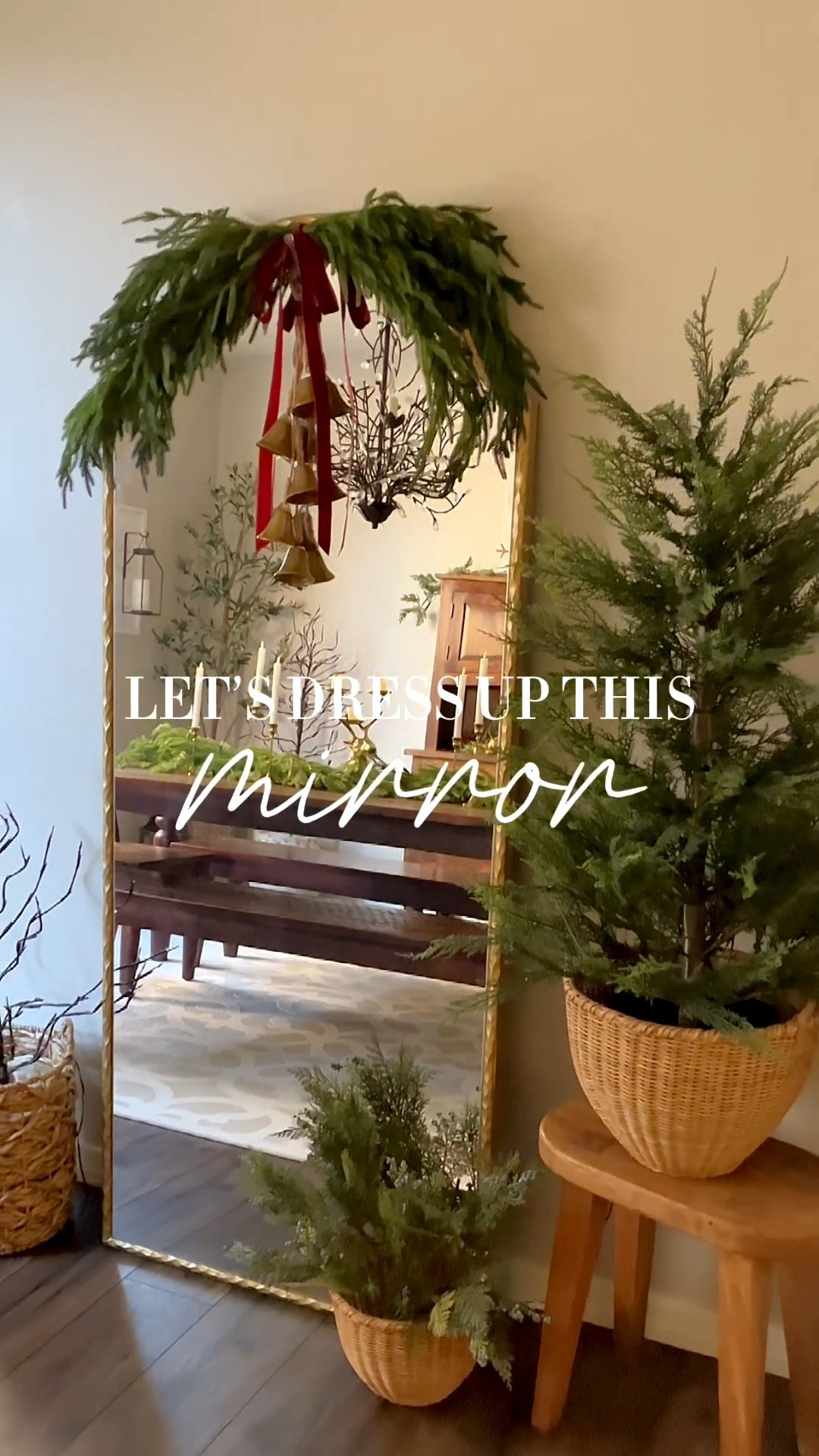 Let’s dress up this mirror!  Follow @lifeinmyarizonahome on Instagram for more holiday ideas and inspiration. 

I added some greenery to the mirror in my dining room using four 36 inch Norfolk stems that I attached together with floral wire.  Velvet ribbon and hanging gold bells help complete the look.  
These beautiful matching baskets in the small and medium size on the right side were perfect for the 4 foot cypress tree, and in the smaller basket I added stems. 
The other side of the mirror has one of three light up branch trees that I have around the dining room.  

#christmasdecor #holidaydecor #christmas #holidayhome 

#LTKHome #LTKSeasonal #LTKHoliday