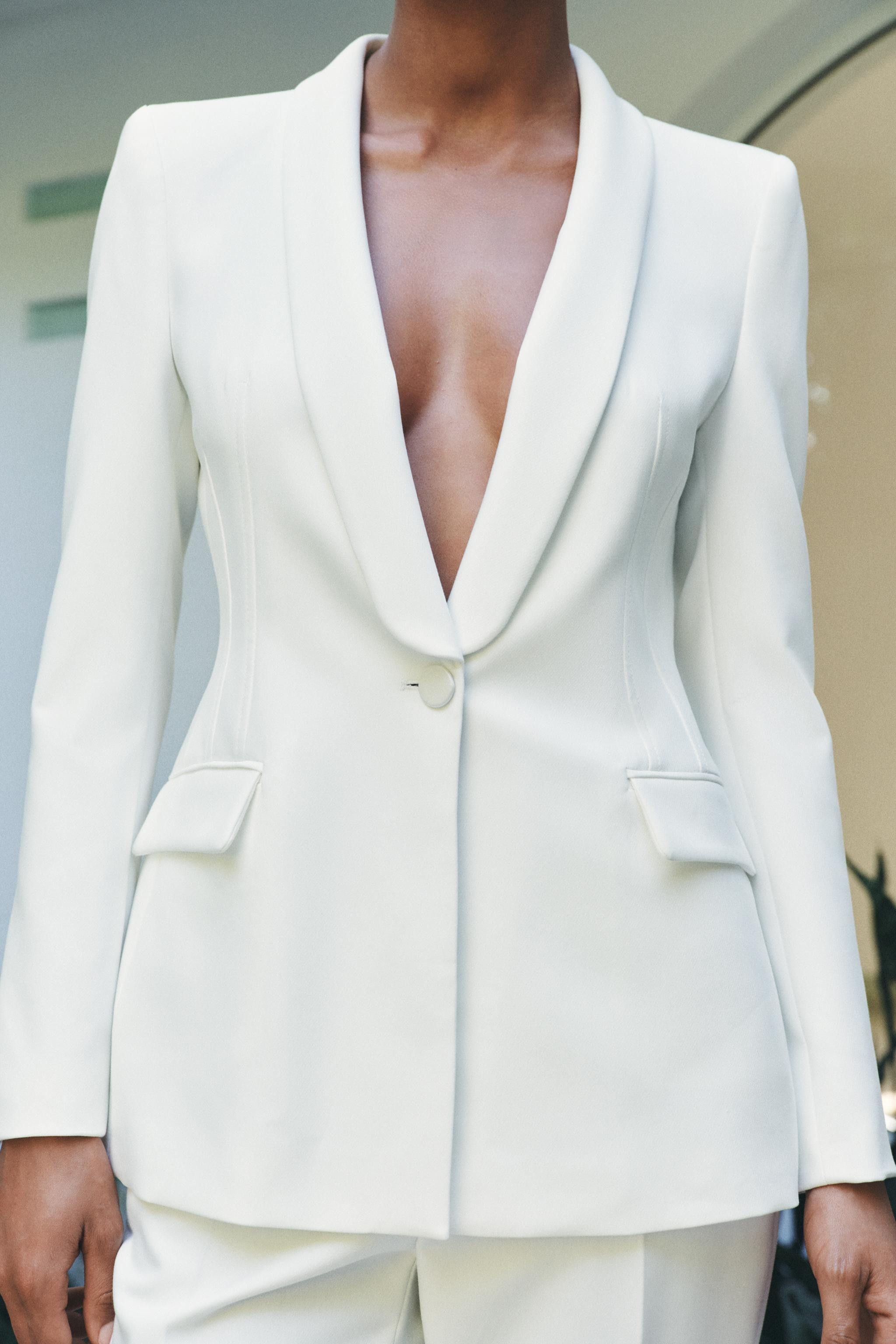 Blazer con colletto a revers, maniche lunghe e spalline. Vita aderente. Tasche anteriori con patt... | Zara IT