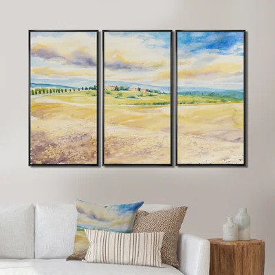 three panel framed canvas of a rustic Italian landscape over a sofa