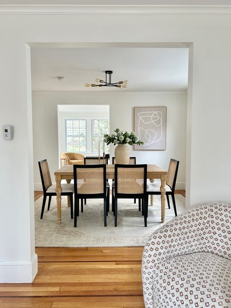 Dining room with cane and black chairs.

#diningroom

#LTKhome