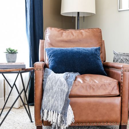 Cozy leather reading corner chair with a touch of spring decor 

#LTKSeasonal #LTKhome