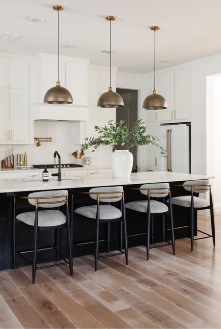 Transitional kitchen decor with brass dome pendants that are absolutely stunning, upholstered counter stools, oversized vase and more. Counter stools and more are on sale 

#LTKhome #LTKstyletip #LTKsalealert