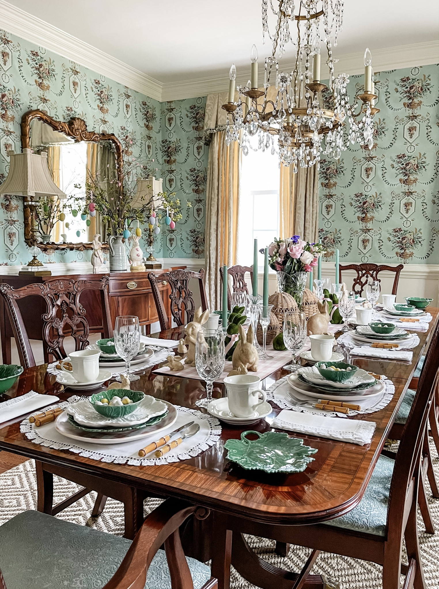 Strolling through my Spring archives, I stumbled upon an Easter table from years past that's too charming not to share. 🌸🐰✨ As I'm crafting this year's setup, I thought this throwback might spark some inspiration. Picture this: delicate vintage white table linens setting the stage, topped with a playful mix of pink and white gingham plates and whimsical green and white cabbage tableware. Each guest's spot is marked by a tiny green cabbage bowl brimming with pastel chocolate eggs, adding a touch of whimsy. 🐰💕 Bamboo flatware lends a quaint charm, while crystal and rattan glassware elevate the affair. The centerpiece? A pink and white gingham runner, flanked by brown ceramic and mossy green rabbits donning pink neckties, rattan eggs, and a crystal vase bursting with a Spring bouquet. And let's not forget the buffet, dressed in Easter finery with bunnies and festive branches in a green ceramic pitcher. It's a scene ripe for celebration! Hosting Easter this year? I'd love to hear how you're making it memorable. Let's swap stories and inspire each other! 🌷🍽

#LTKhome #LTKSeasonal #LTKstyletip