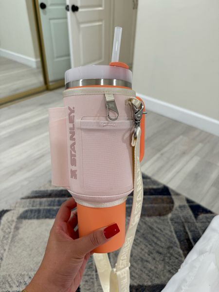 Okay this Stanley color is perfection!!!! It’s like a sherbet ice cream!!!!! So cute!!! And how genius is this little strap/storage thing you can put on it?!? You can put your cards, wallet, lip gloss, keys you name it!!! 

#LTKFitness #LTKFindsUnder100 #LTKGiftGuide
