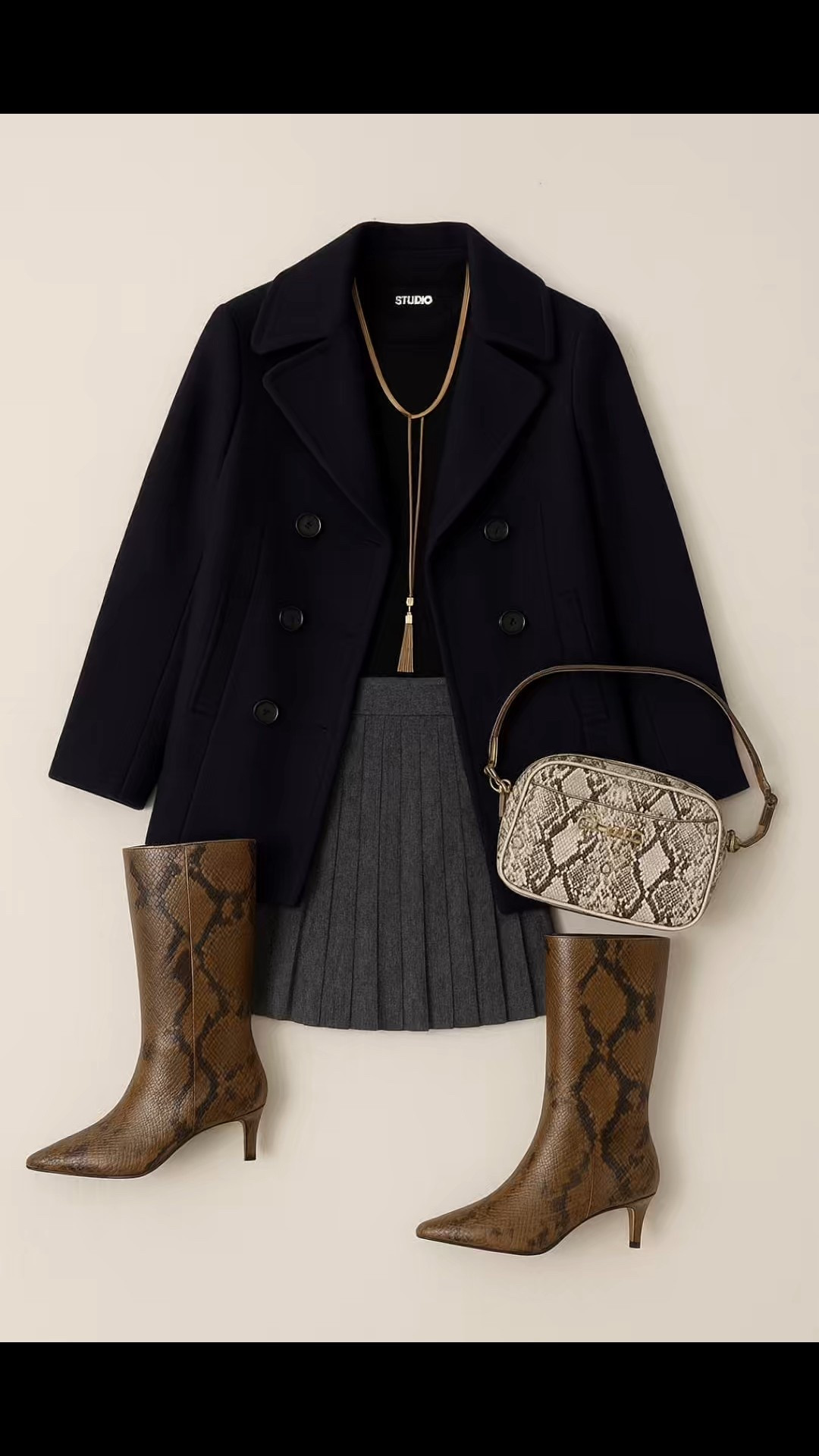 This quiet-luxury look is the definition of timeless chic tailored, textural, and elevated. I paired a navy wool peacoat with a sleek black cashmere sweater and a pleated gray mini for that polished-meets-playful balance. Snake-print boots and a matching crossbody add a bold statement moment while keeping things neutral and wearable. Perfect for fall outings, city strolls, or cozy dinner dates this look proves effortless sophistication never goes out of style. @NordstromRack #NordstromRackPartner #RackScore