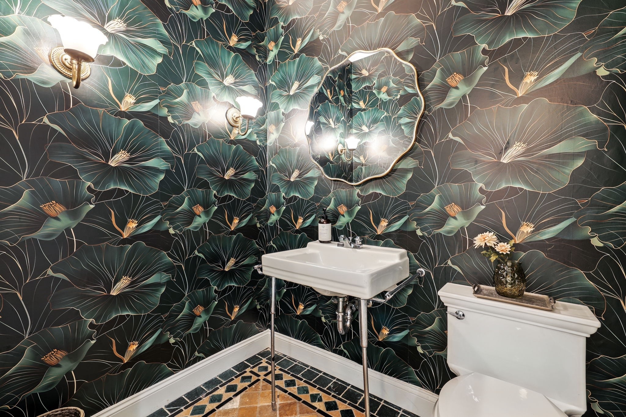 This powder room proves that small spaces can still make a big statement. The black and green floral wallpaper sets the tone for a space that feels both grounded and glamorous.


📷 by Houlihan Lawrence
