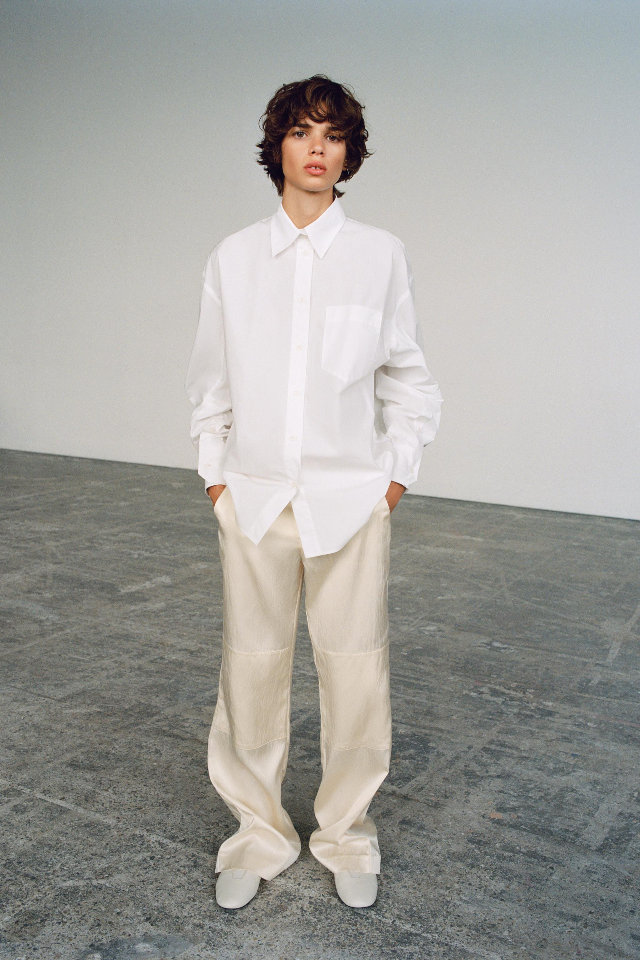 Mid-waist trousers made from satin fabric. Featuring side pockets, overlay fabric detail at the k... | Zara UK