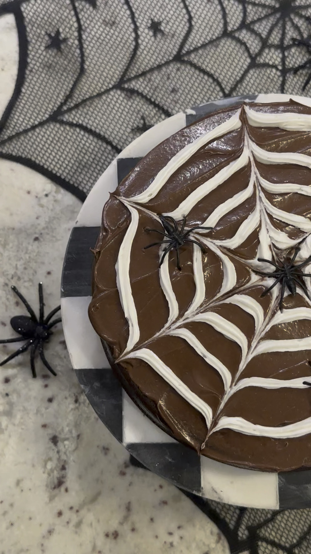 The EASIEST spiderweb cake!! I made a boxed chocolate cake and used chocolate icing. Then swirled on the white icing using a toothpick to run across the swirl to make a spiderweb. Added the spider rings for fun! Linking everything you need! 🕷️🕸️

#LTKHome #LTKVideo #LTKSeasonal