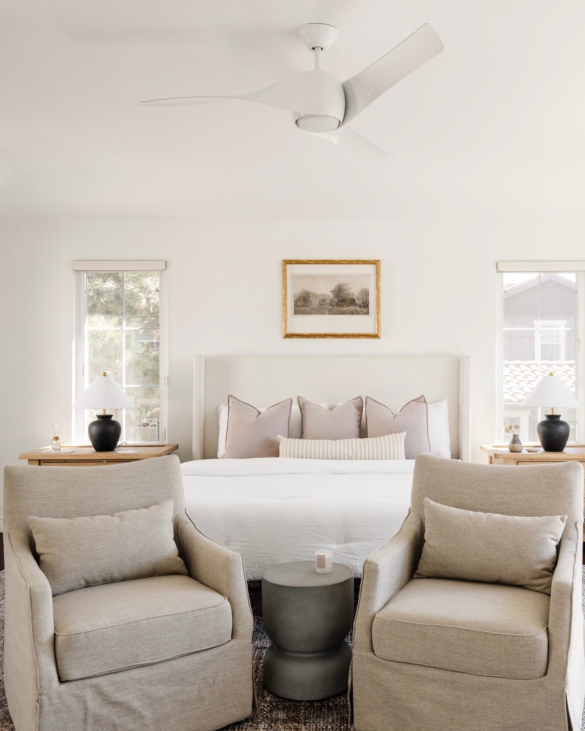 Bedroom with light wood nightstands and white upholstered bed and swivel side chairs 

Bed, linen, slipcover, art above bed, bedroom art

#LTKHome