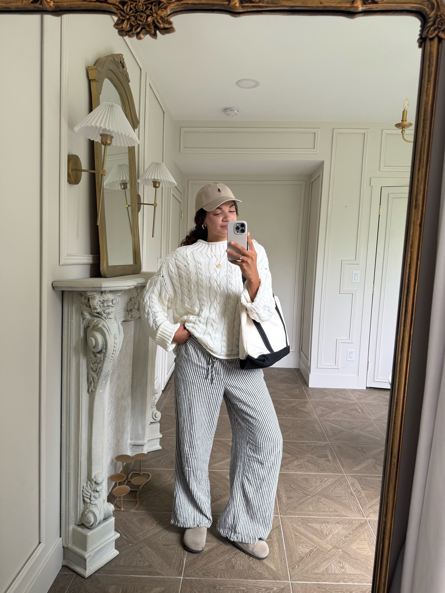 Casual spring outfit or cooler summer night: rollneck cable knit sweater, striped lightweight (like linen or cotton) pants, clogs, boat tote, baseball cap

#LTKootd #LTKdayinmylife