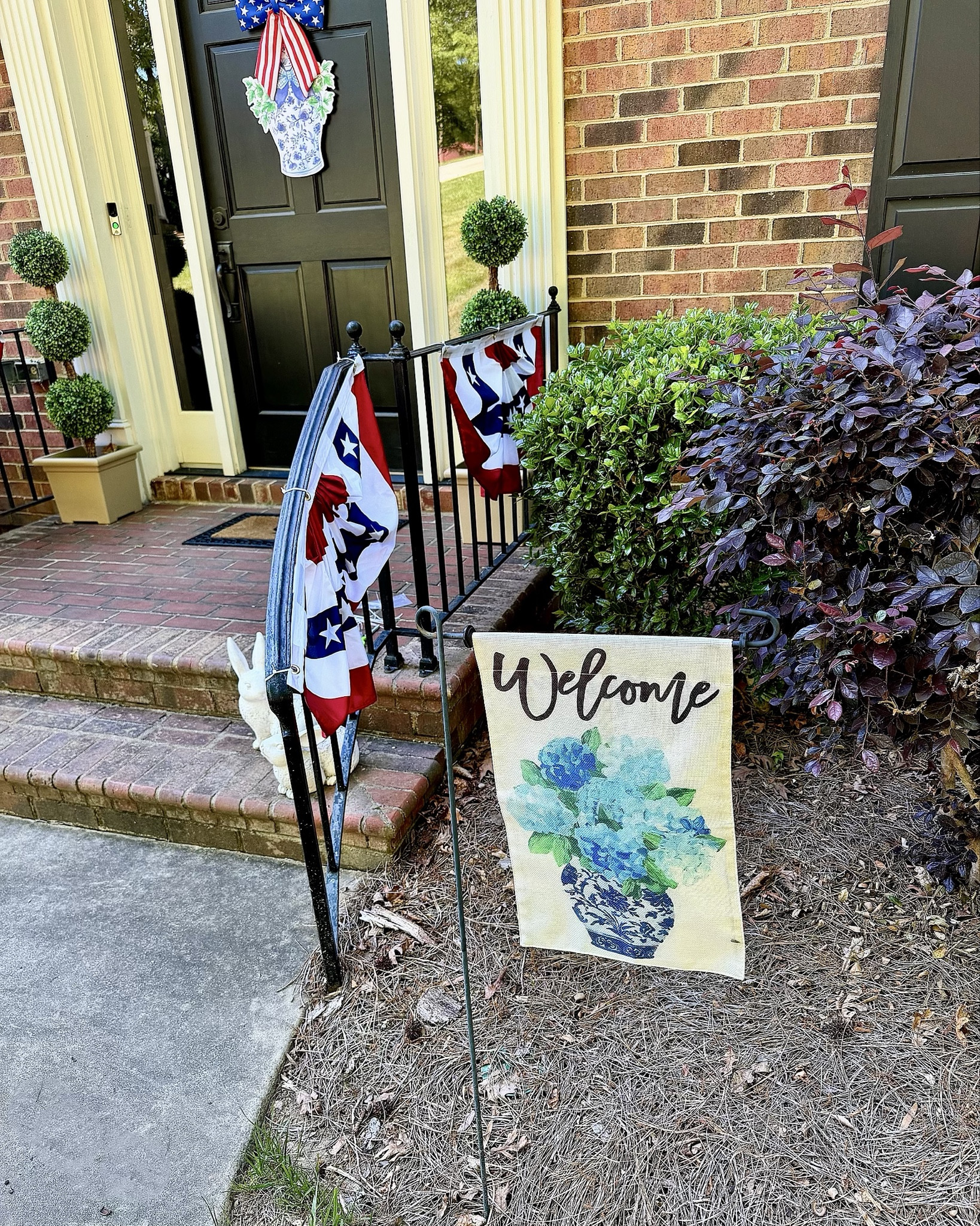 Patriotic Front Porch Decor 🇺🇸 Blue & White Chinoiserie Hydrangea Welcome

Classic Americana meets chinoiserie 💙🇺🇸 I styled our front porch with patriotic bunting, a red white & blue bow door hanger, and this hydrangea garden flag for a fresh summer look. The layered doormats, topiary trees, and pops of blue and white keep it feeling preppy and polished—perfect for Memorial Day through the 4th of July!

Everything is linked to recreate this charming front porch setup ✨

patriotic front porch decor, 4th of july porch ideas, americana outdoor decor, chinoiserie hydrangea, blue and white porch styling, summer porch decor, preppy home style, outdoor entryway ideas, garden flag styling, outdoor topiary, Mother’s Day gifts 

#LTKSeasonal #LTKHome #LTKmomlife

#LTKSeasonal #LTKHome #LTKmomlife