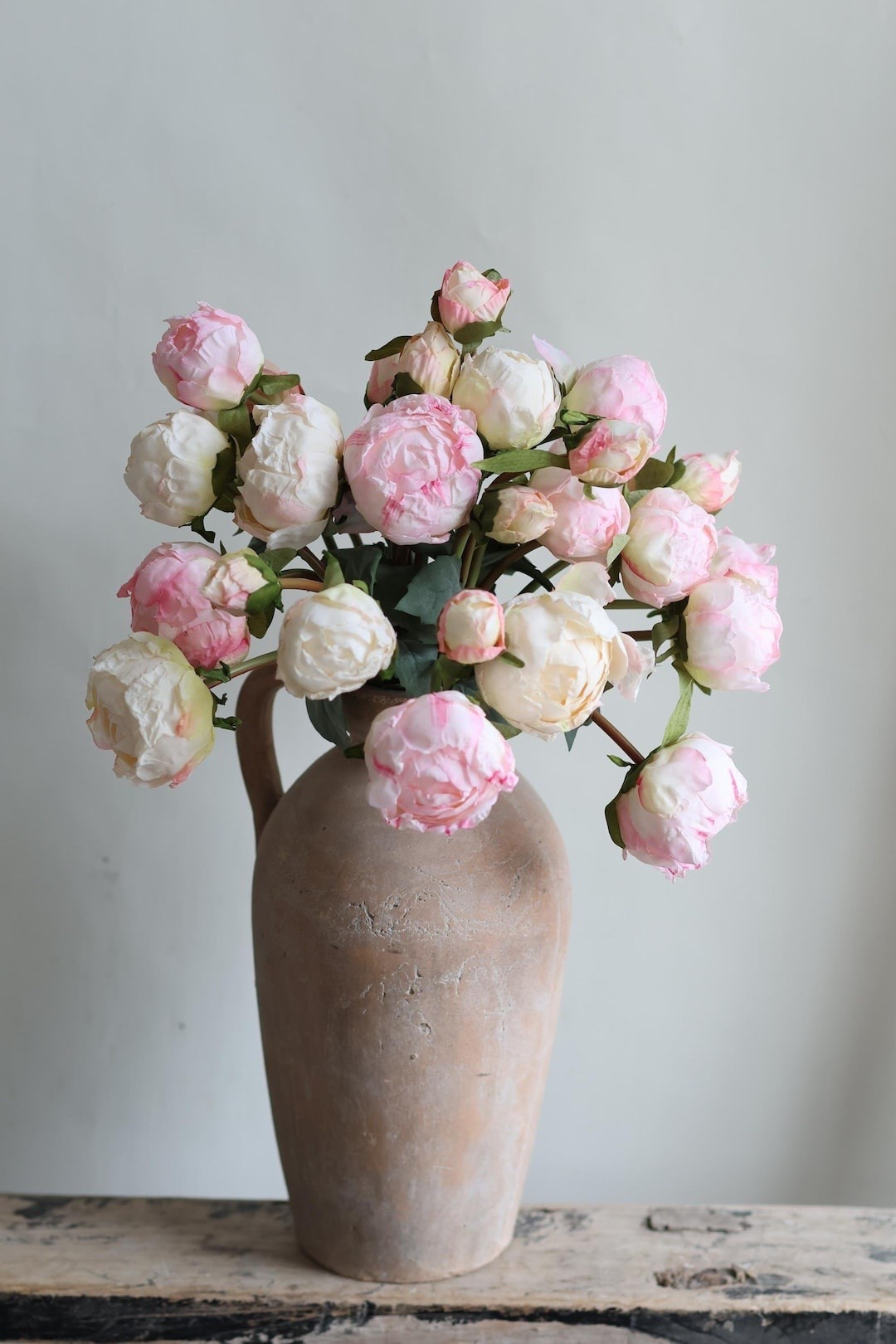 Create your own dreamy floral arrangements with these beautifully crafted faux peony bundles. Featuring soft dried-look fabric petals in white and pink, each bundle includes multiple blooms and buds for a full, natural design. With wired stems that are easy to bend and style, these peonies are perfect for centerpieces, wedding décor, or everyday home styling that stays beautiful season after season.

#LTKHome #LTKStyle #FauxFlowers #PeonyDecor #HomeDecorFinds #WeddingDecor #FloralArrangement #SpringDecor #FarmhouseDecor #CenterpieceIdeas #HomeStyling #LTKFinds #FloralDecor #NeutralHome #DecorInspo

#LTKWedding #LTKSeasonal #LTKHome