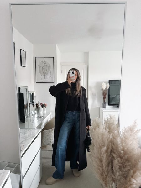 Casual winter outfit, blue denim wide leg jeans, ultra mini Ugg, black jumper, black longline coat. 

#LTKstyletip #LTKSeasonal #LTKeurope