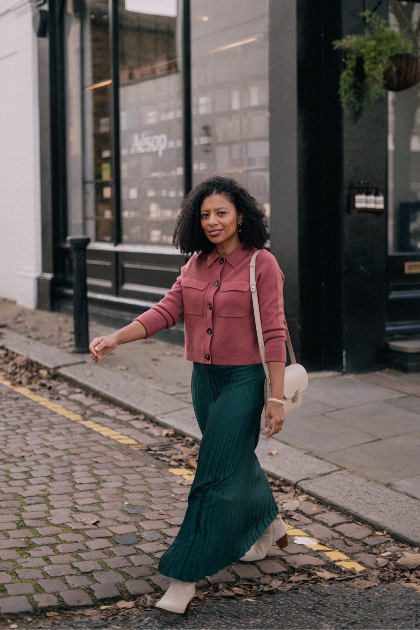 Sézane Spring Outfit: Pink Betty Cardigan, green pleated skirt and ecru boots. 

#LTKSpringSale #LTKover40 #LTKeurope