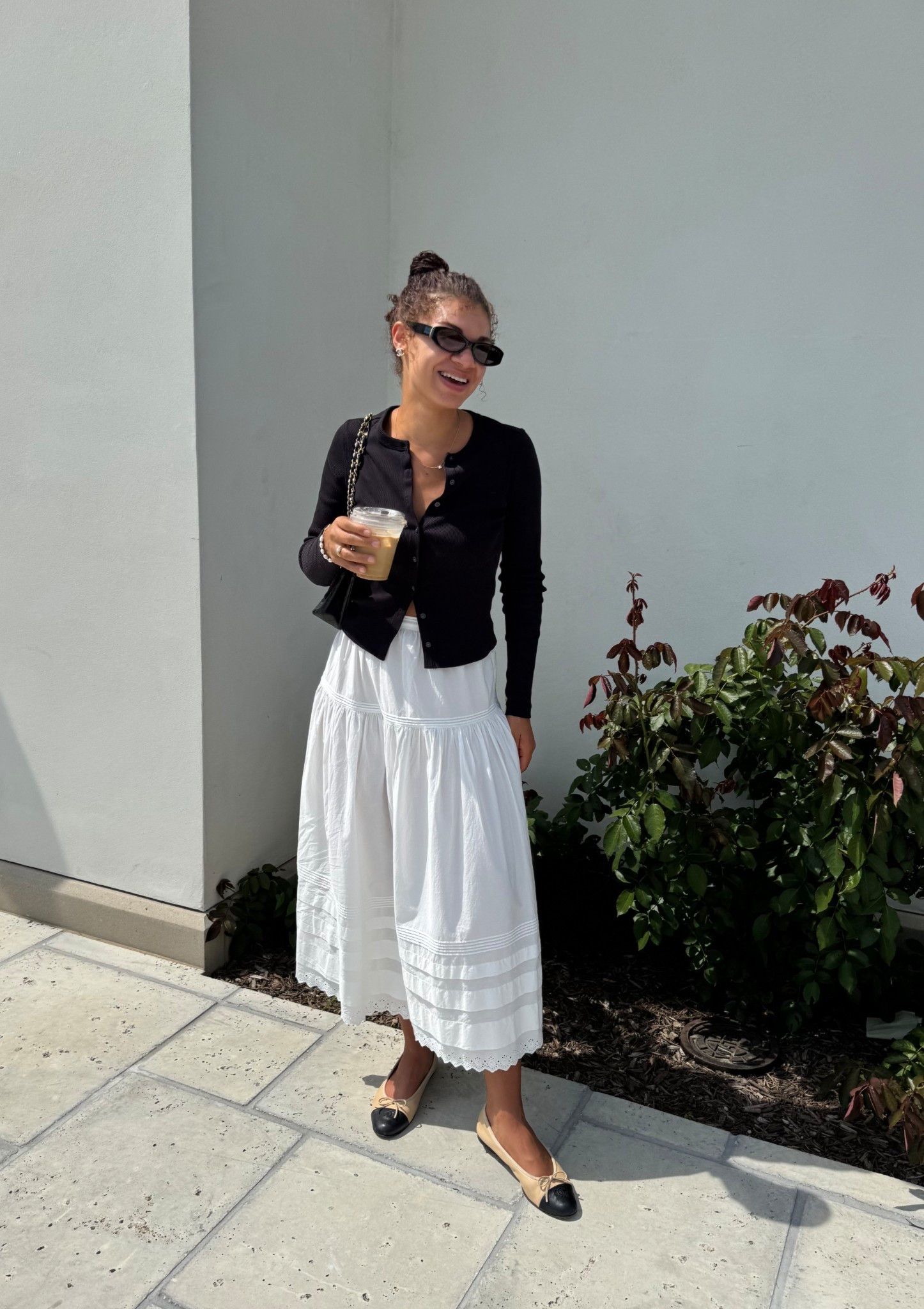 Black cardigan, white midi skirt, cap for ballet flats, oval sunglasses, pearl and gold accessories 

#LTKStyleTip #LTKSeasonal