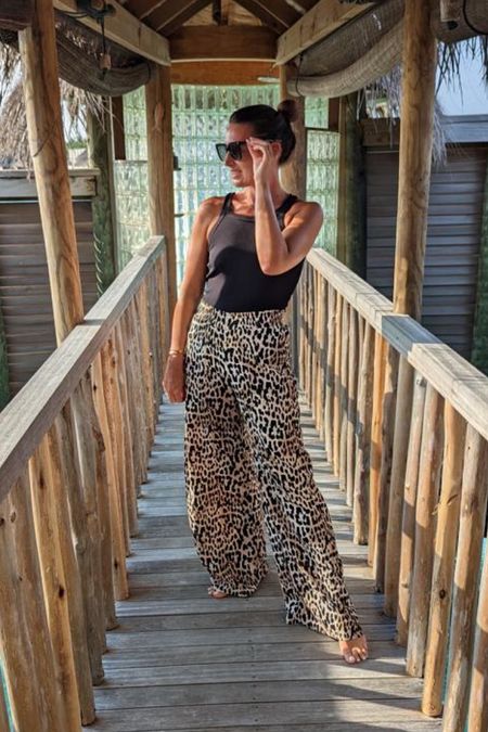 Black halter top, leopard print pants, black sunglasses, beach outfit, summer ootd 

#LTKswim #LTKstyletip #LTKSeasonal